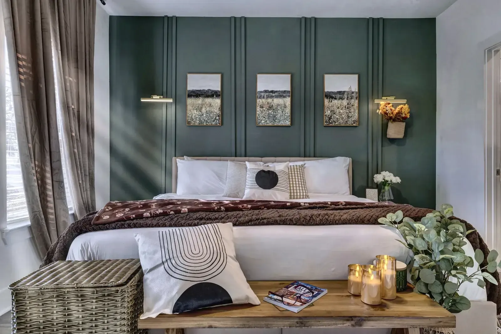 Bedroom with green paneled wall and king bed